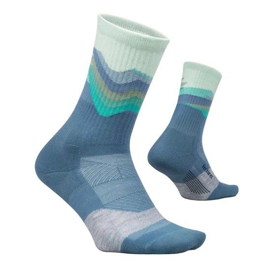 A pair of crew socks with a blue and mint green mountain-wave pattern, displayed on a light beige background.