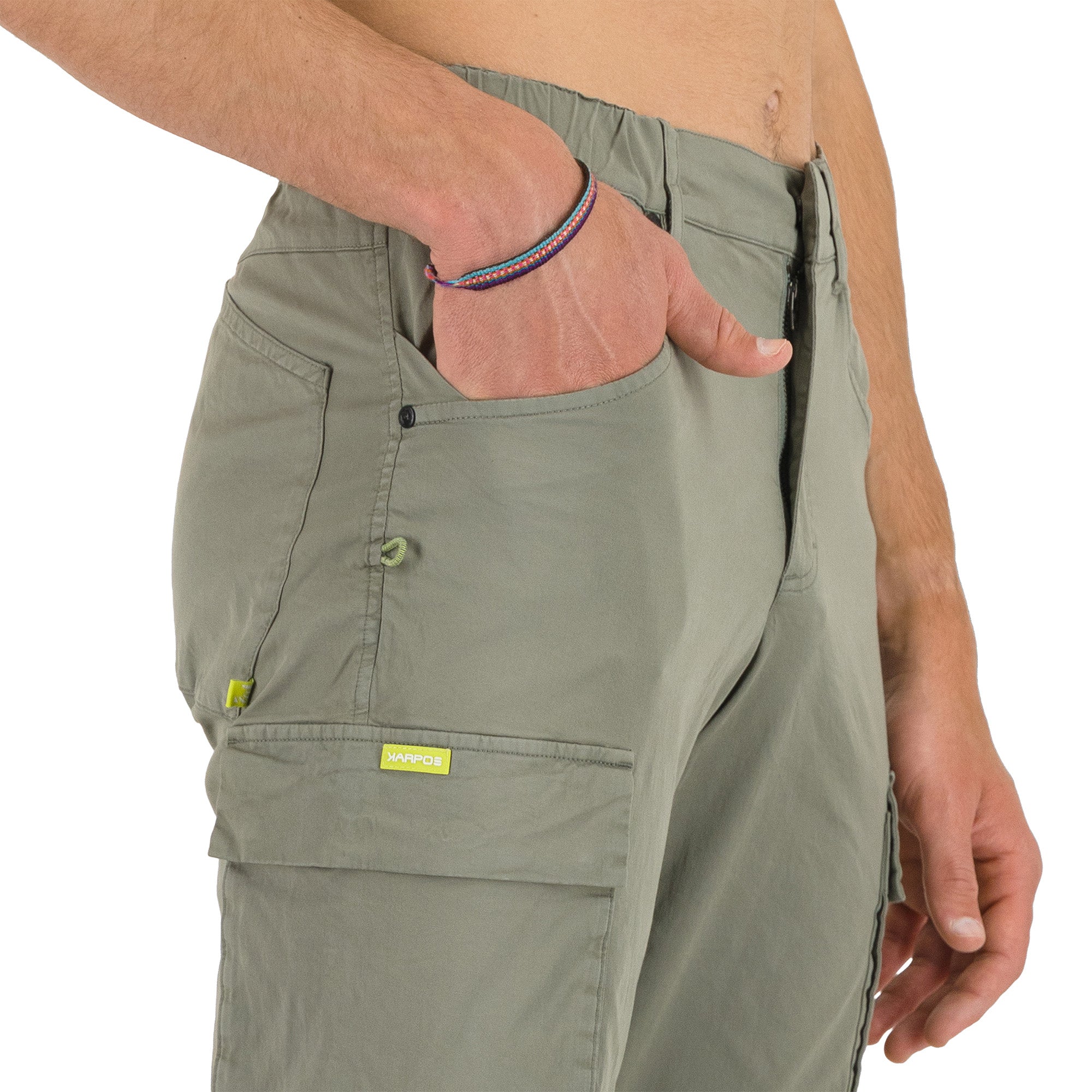 Person wearing green cargo pants with a visible brand label on a white background
