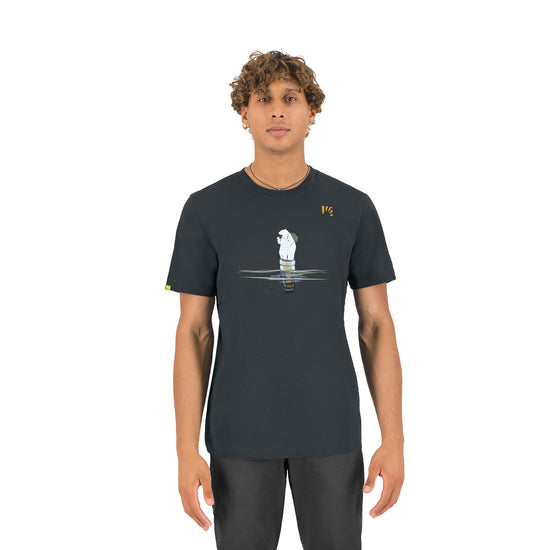 Person wearing a dark grey t-shirt with a graphic design on a white background