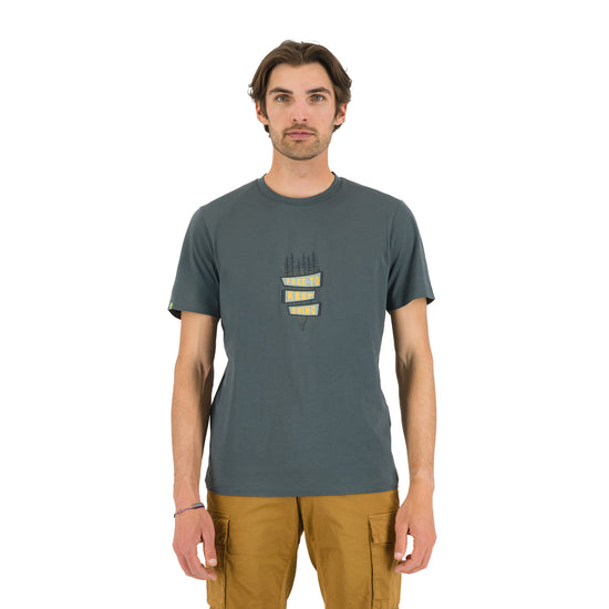 A man wearing a grey Karpos t-shirt with a graphic on the front