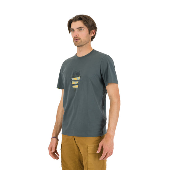 Man wearing a gray t-shirt with a logo on a white background