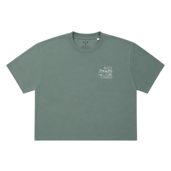A muted sage green short-sleeve crop top t-shirt with a small white graphic on the left chest, displayed flat against a white background.