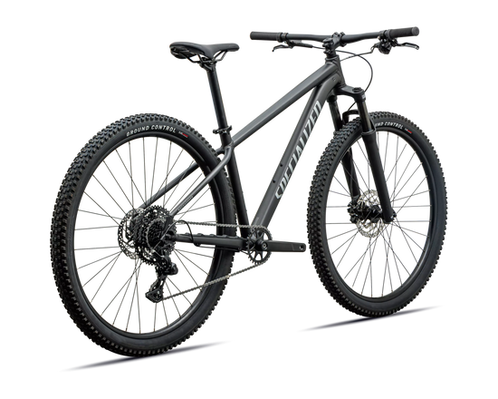 A matte black full-suspension mountain bike with knobby tires, a rear derailleur, and a visible 'Specialized' brand name on the frame, shown against a plain white background.
