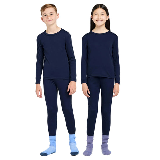 Two children wearing navy long-sleeve shirts and pants on a white background