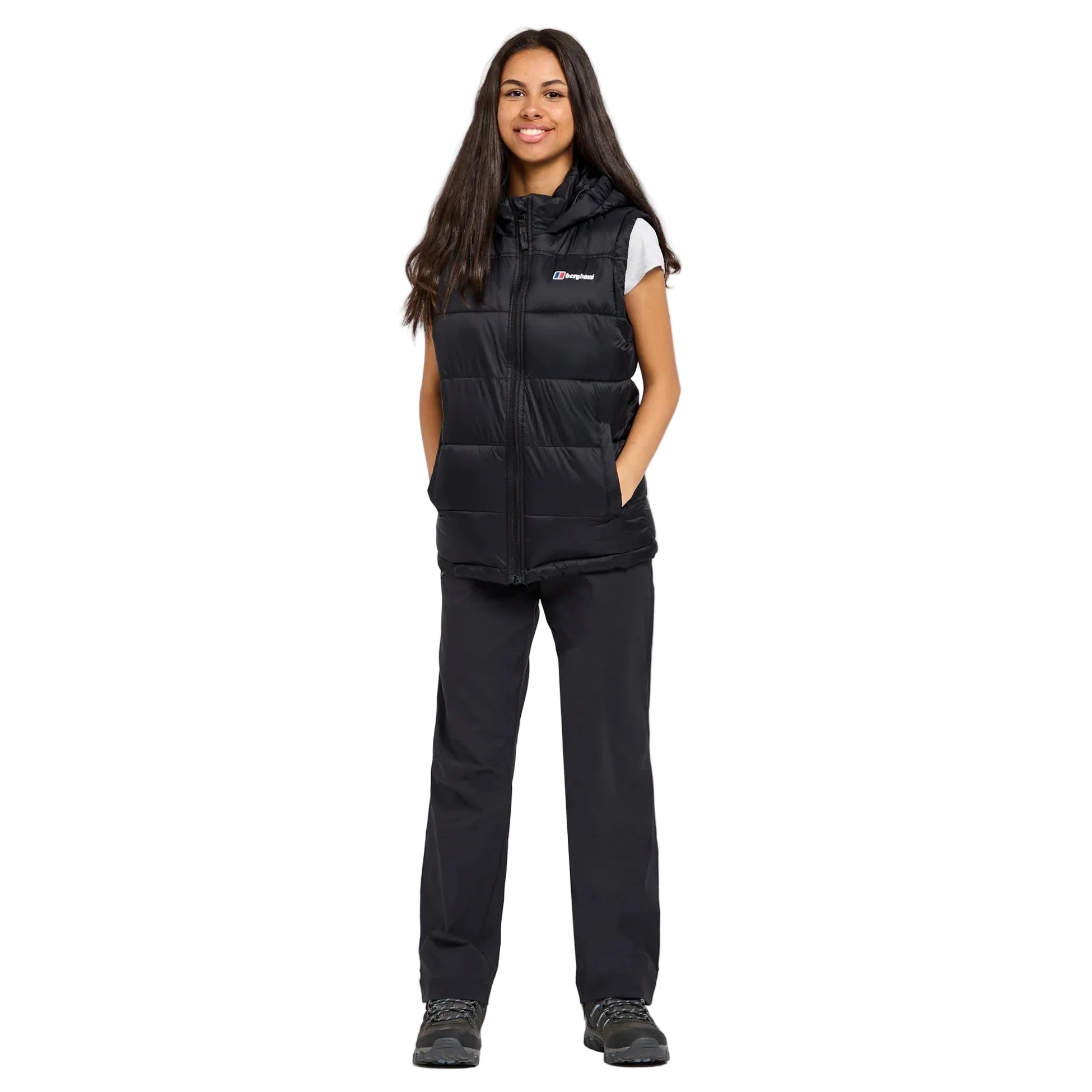 Person wearing a black insulated gilet on a white background