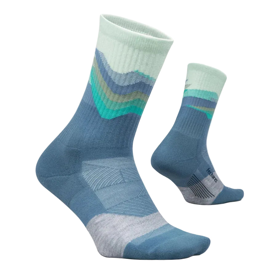 A pair of crew socks with a blue and mint green mountain-wave pattern, displayed on a light beige background.