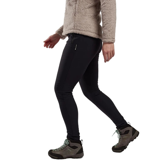 Person wearing black leggings and hiking boots on a plain background