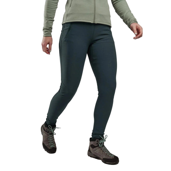 Person wearing green jacket and dark green pants with hiking boots on a light white background