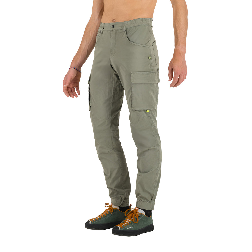 Person wearing green cargo pants on a white background