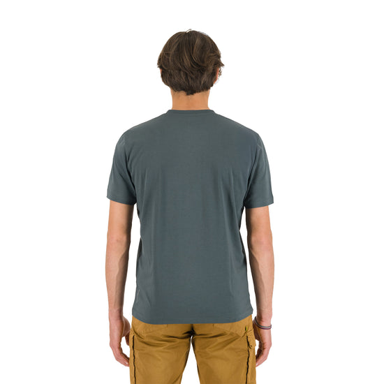 Back shot of a man wearing a gray Karpos t-shirt.