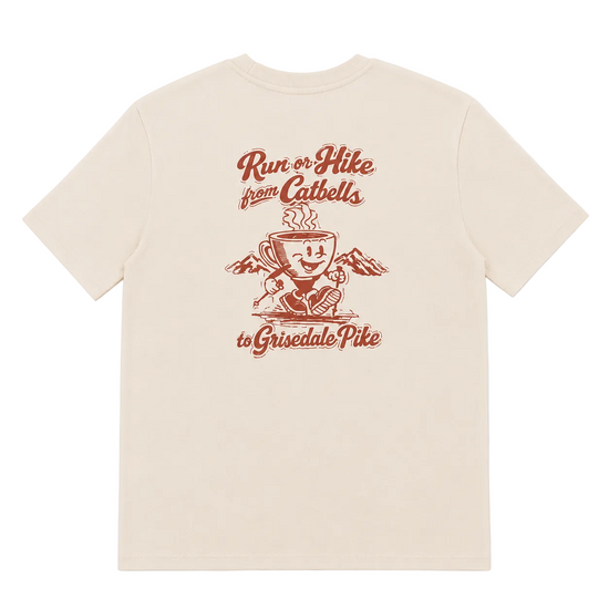 A cream-colored short-sleeve t-shirt with a red graphic print on the front. The graphic features a coffee cup character with mountains and the text 'Run or Hike from Cathbells to Grisedale Pike'.