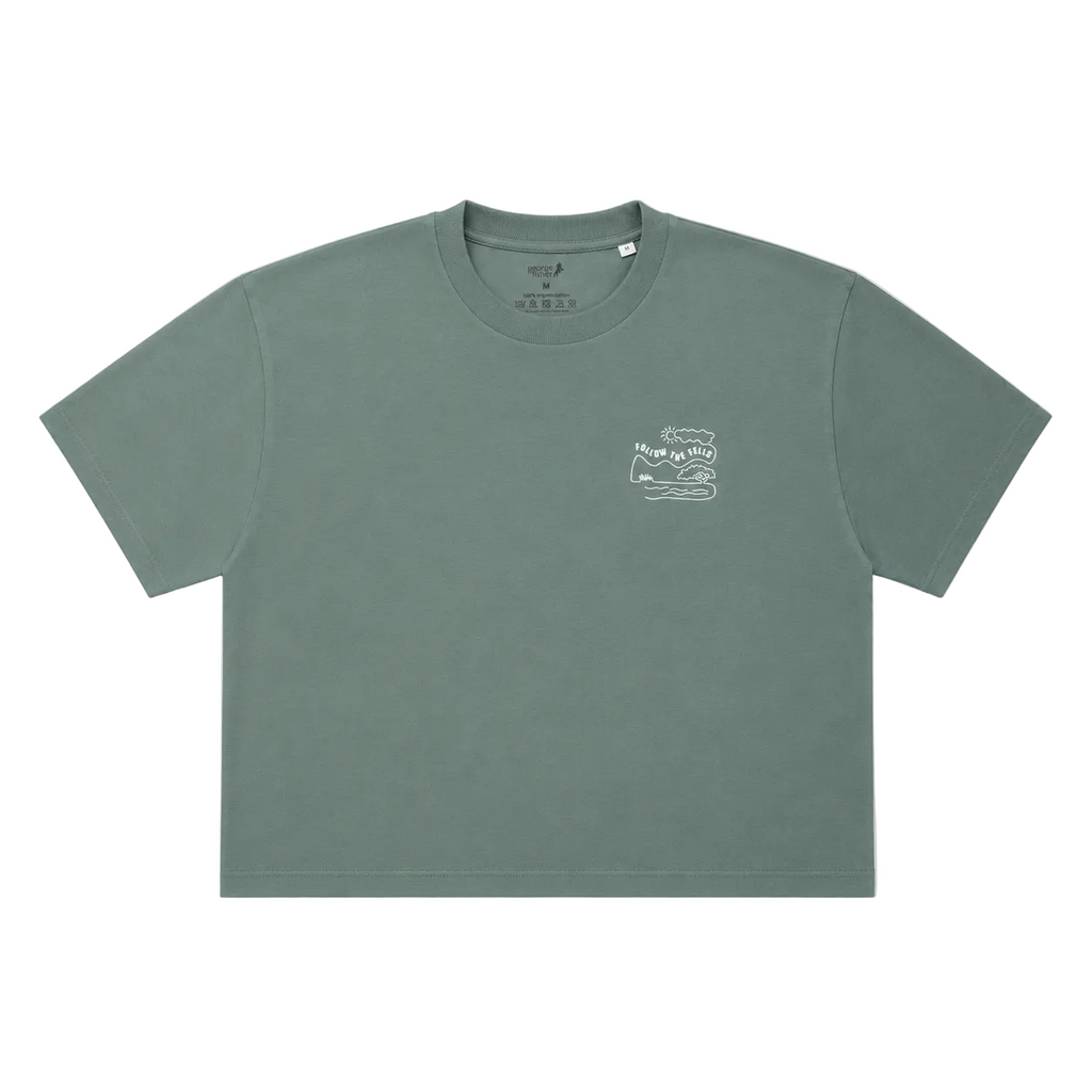 A muted sage green short-sleeve crop top t-shirt with a small white graphic on the left chest, displayed flat against a white background.