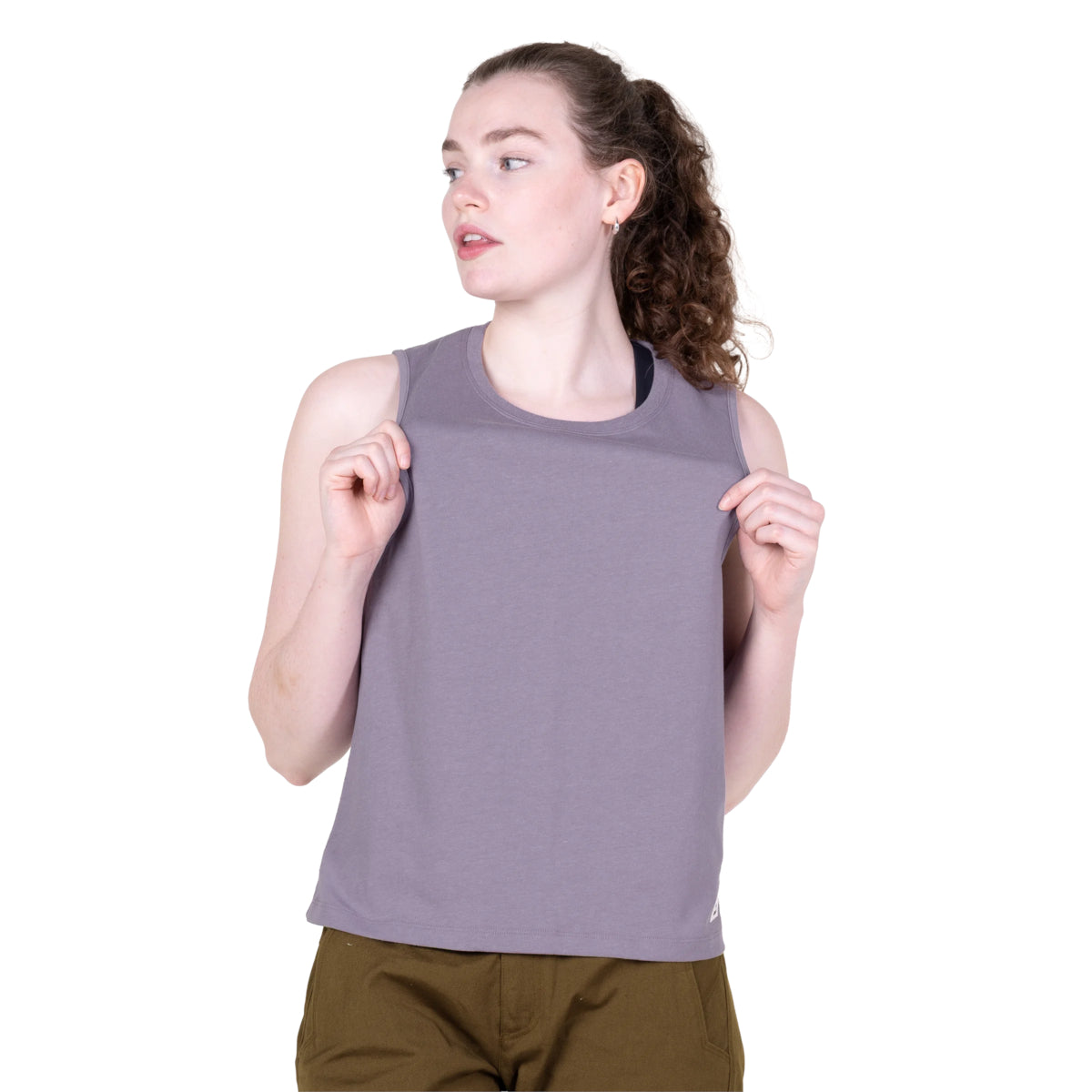 Woman wearing a sleeveless gray top on a white background