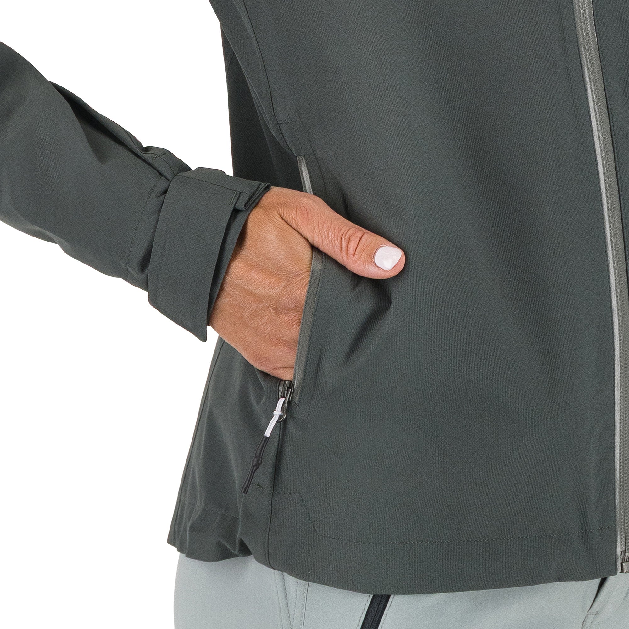 Person wearing a dark gray jacket with a hand in the pocket on a white background