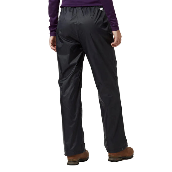 Person wearing black rain pants on a light gray background