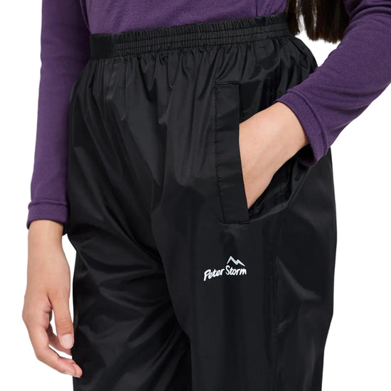 Black pants with a Peter Storm logo worn by a person on a white background