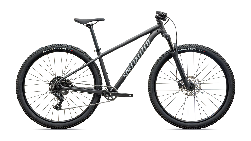 Side profile of a grey front suspension mountain bike on a white background 