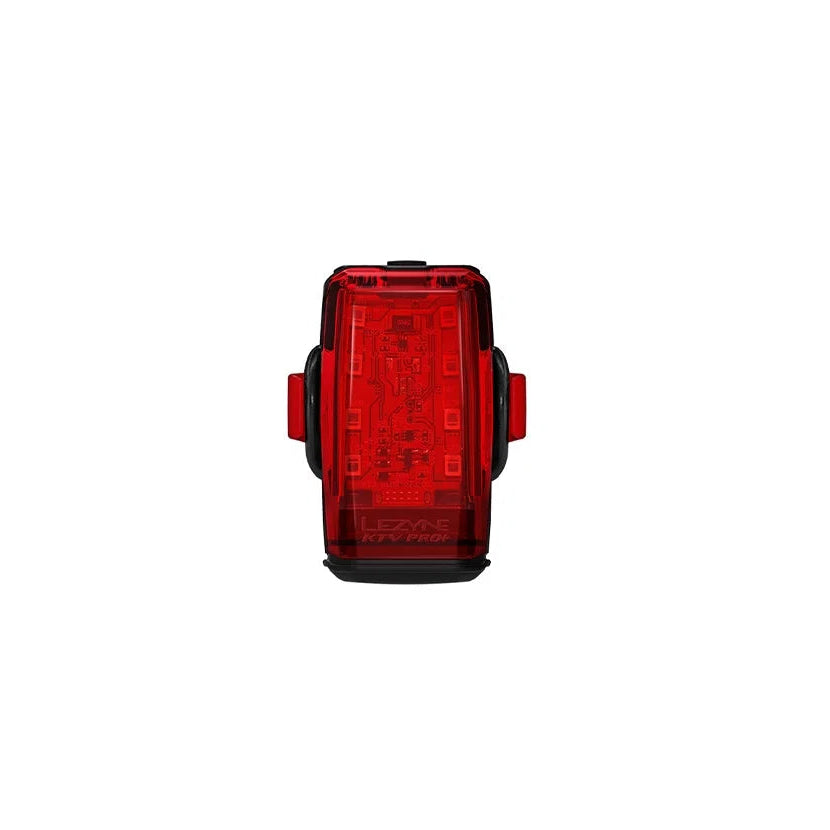 The front of a red rear bike light on a white background
