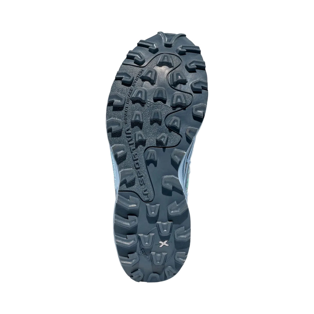 The outsole of a trail running shoe in dark gray and light blue, showing the aggressive tread pattern and the brand name 'TERRAFLOW' on a light gray background.