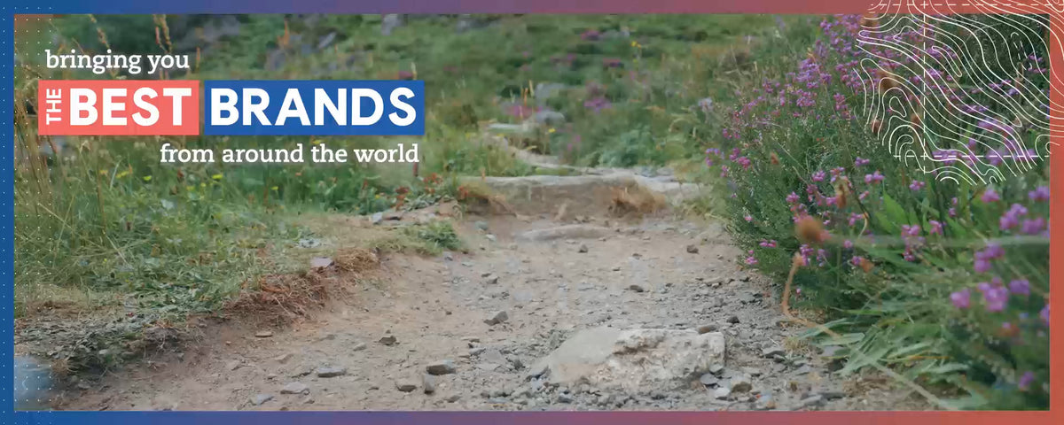 Rocky path with green vegetation and purple wildflowers framed by a colourful contour‑line border promoting top global outdoor brands.