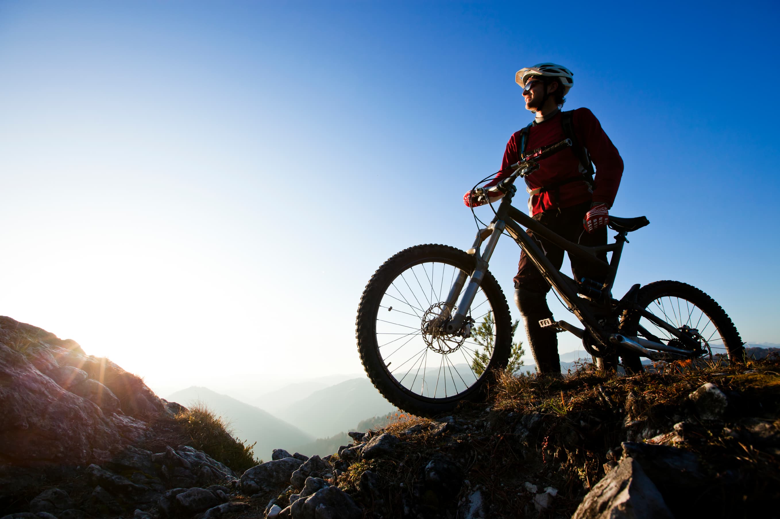 A mountain biker races down a steep technical race course